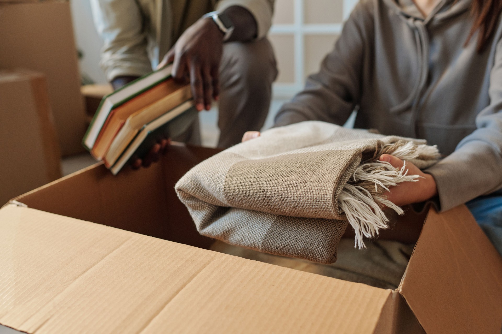 Couple unpacking boxes at home